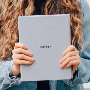 Woman using Coffee and Bible Time prayer binder for daily devotional routine