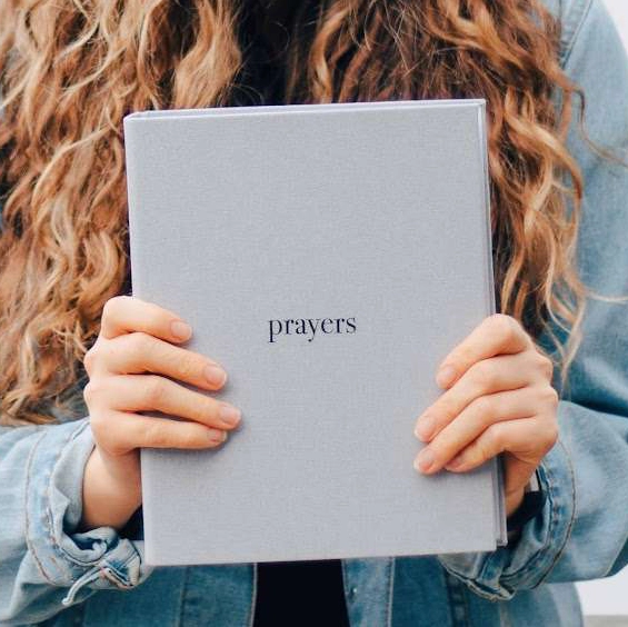 Woman using Coffee and Bible Time prayer binder for daily devotional routine