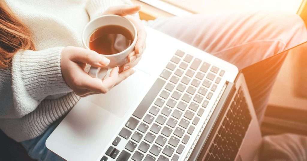 Christian woman enjoying Bible study with coffee and laptop — part of the Coffee and Bible Time online Christian community.