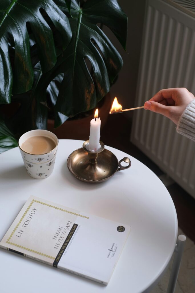 How to Keep the Sabbath Holy: 3 Powerful Ways to Live From Rest, Not For It 6 How to Keep the Sabbath Holy: Starting With Quiet (image: woman's hand lighting candle)