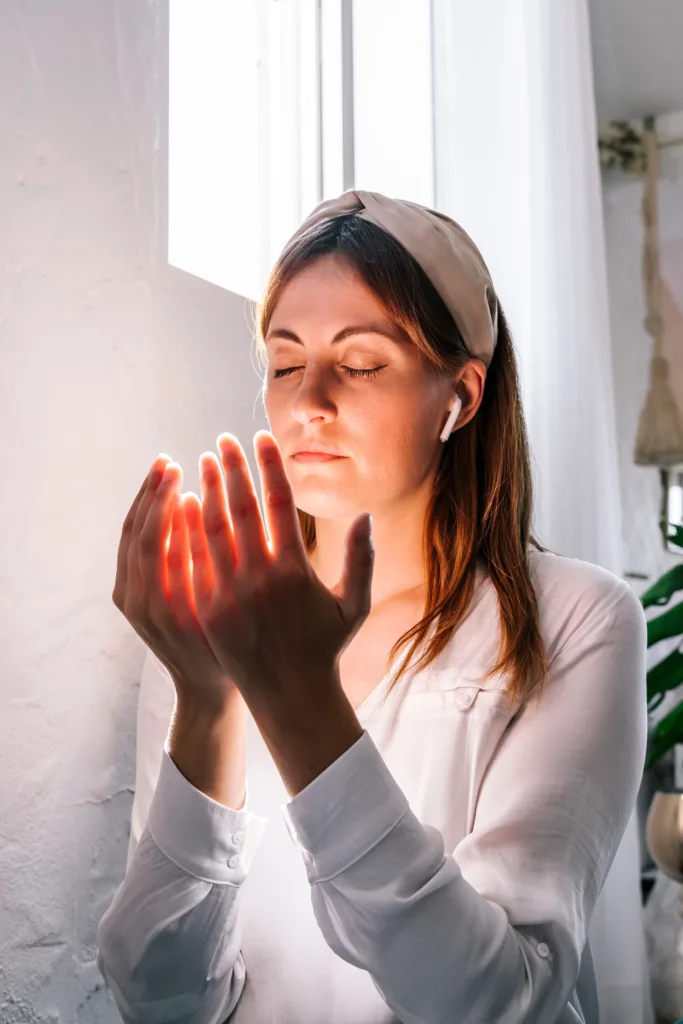 Woman worships God while listening to music for her quiet time. 