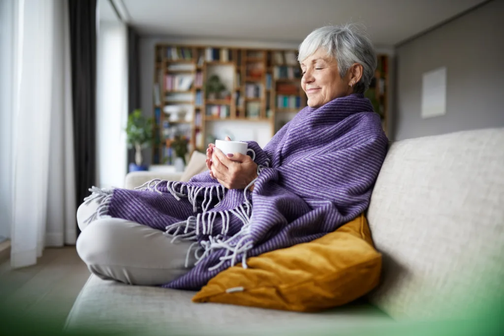 Senior Woman has quiet time in the evening with coffee