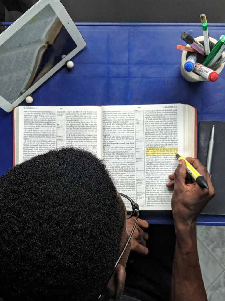 Man highlights the Bible as he works toward understanding Scripture