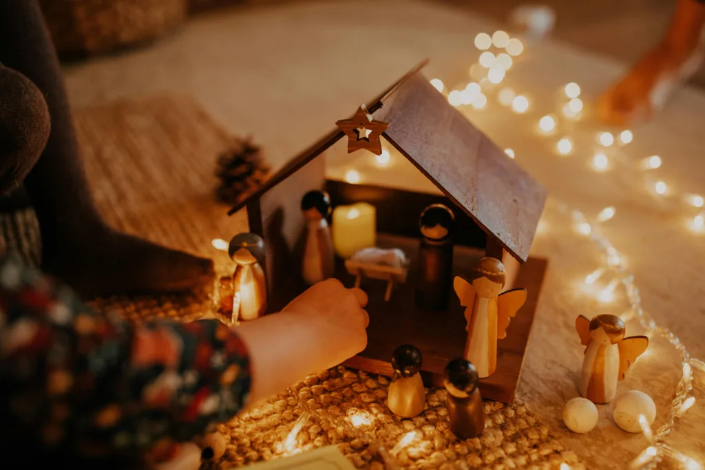 Child playing with nativity set in Advent time