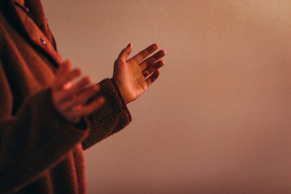 7 Things to Remember When You're Facing Unanswered Prayers; picture of someone holding open their hands in worship or prayer