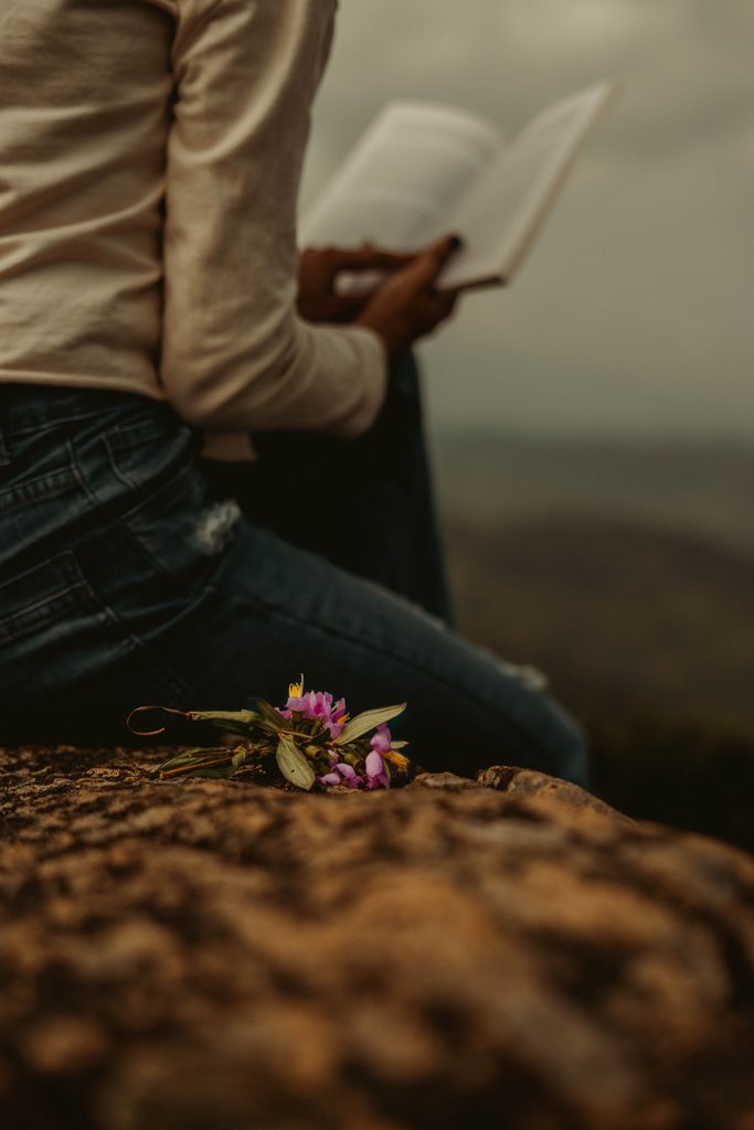 Woman Reading her Bible in Nature image for the post: How to Deepen Your Prayer Life